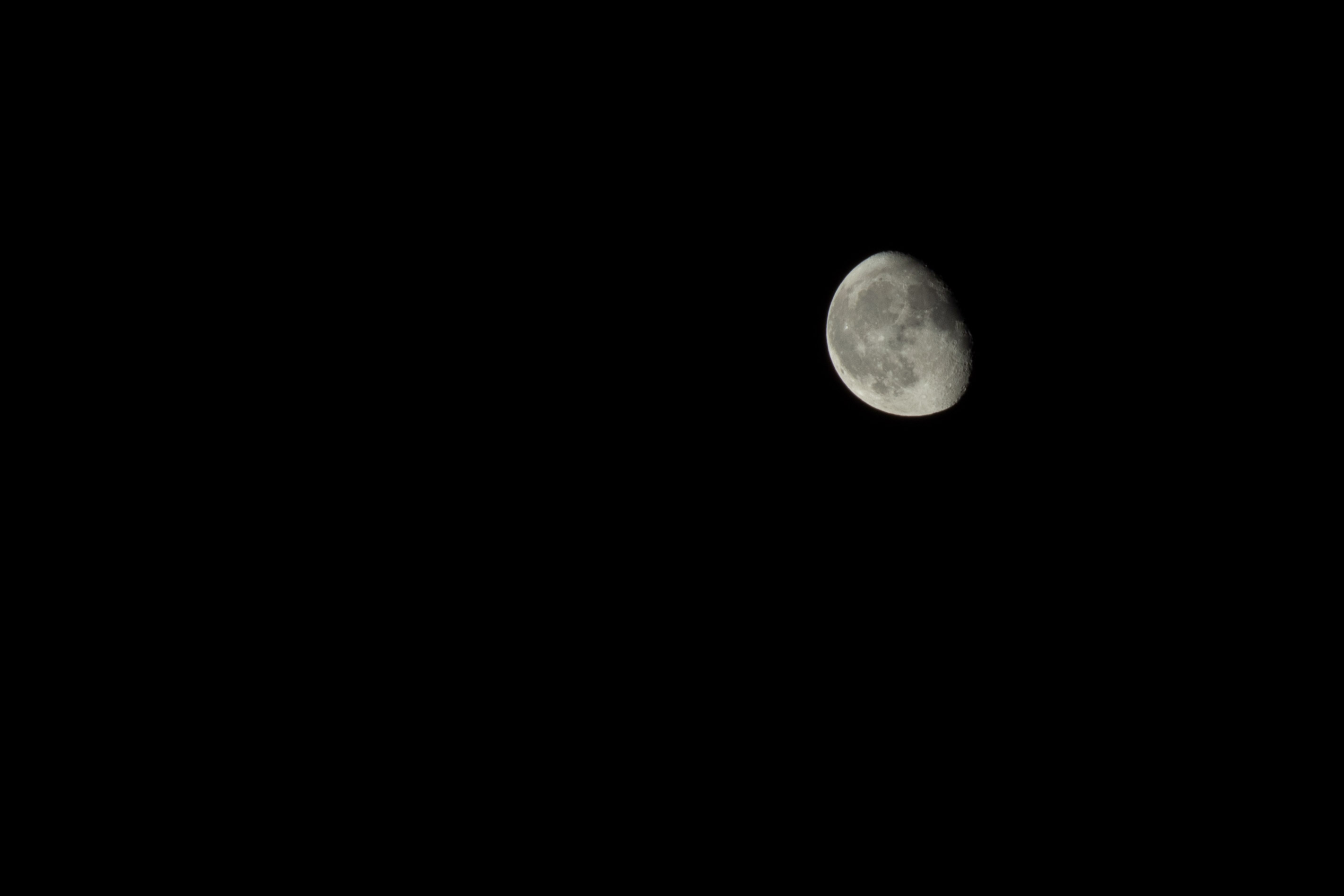 Gibbous moon against a pitch-black sky